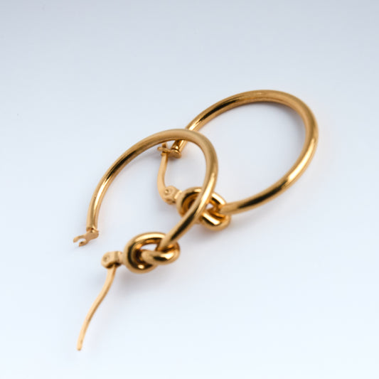 Gold hoop earrings on a white background