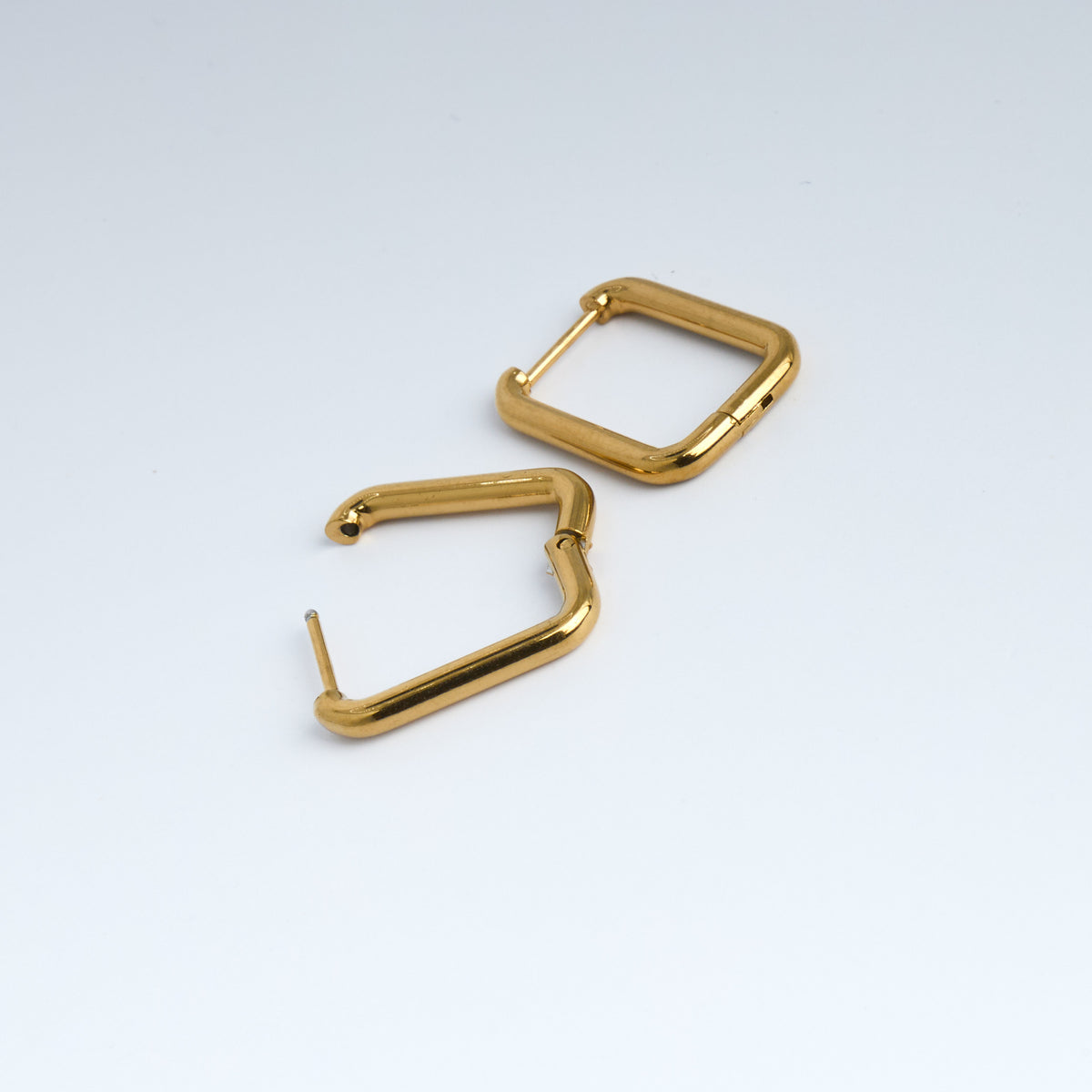 Pair of gold hoop earrings on a white background