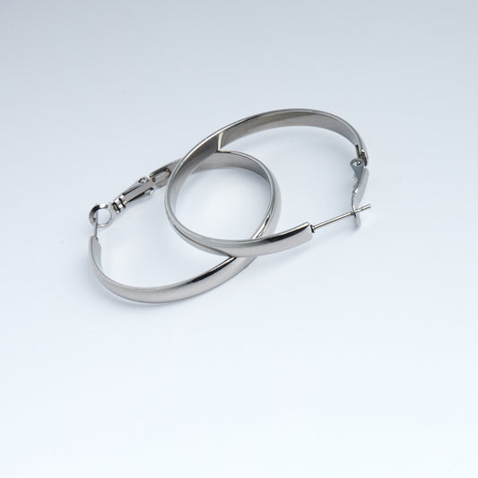 Pair of silver hoop earrings on a light gray background