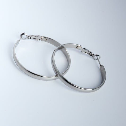 Pair of silver hoop earrings on a light gray background